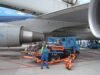 Aircraft fuelling vehicle beside a passenger jet at Amsterdam Schiphol (archive photograph)