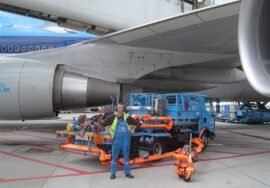 Aircraft fuelling vehicle beside a passenger jet at Amsterdam Schiphol (archive photograph)