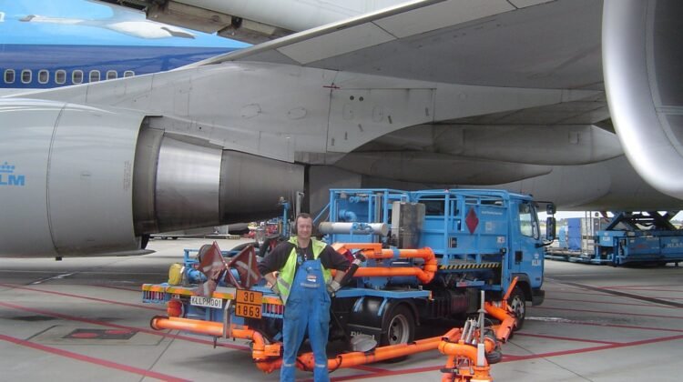 Aircraft fuelling vehicle beside a passenger jet at Amsterdam Schiphol (archive photograph)